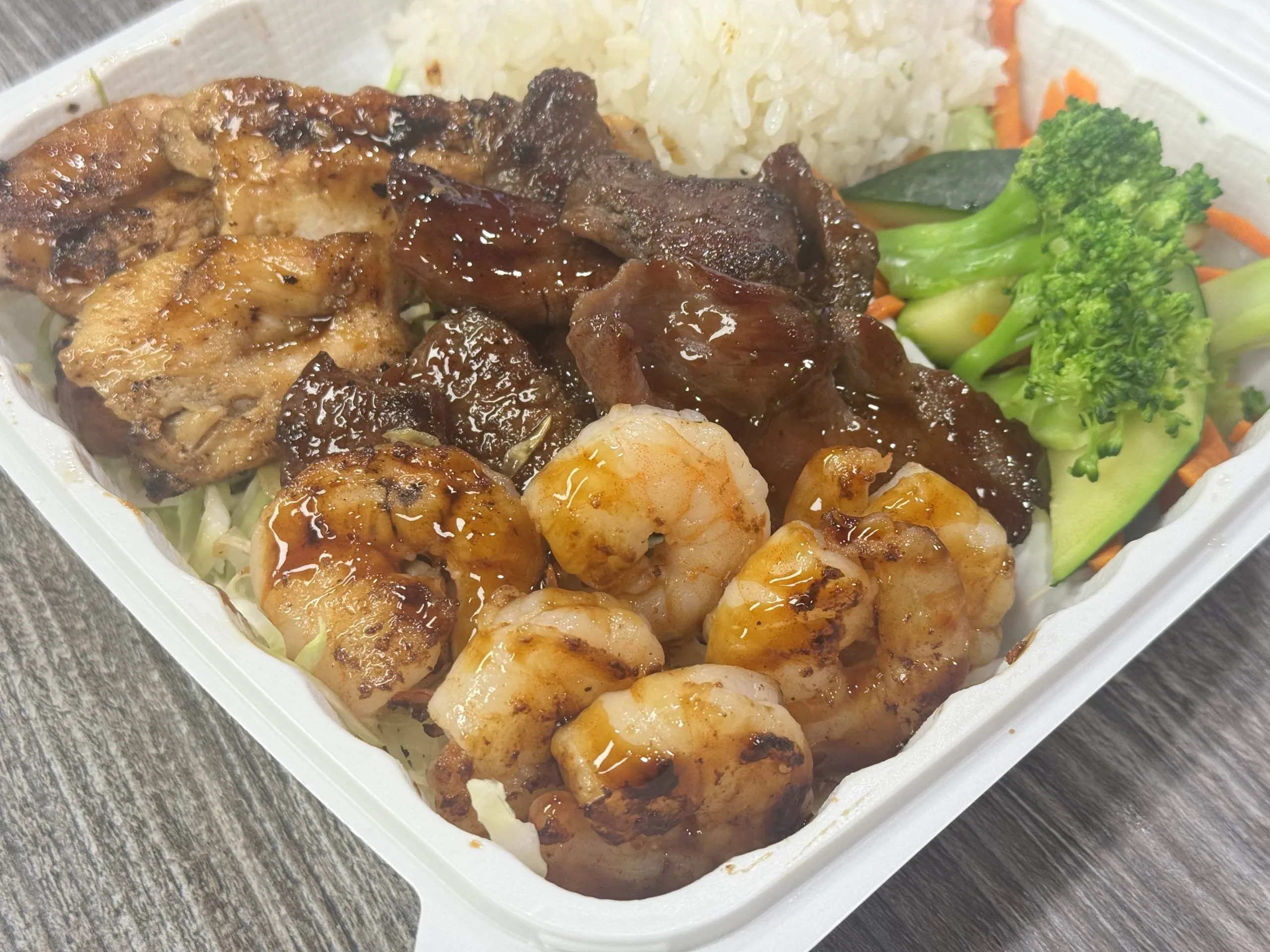 Mixed chicken, beef and shrimp in teriyaki sauce at Chop Sushi & Grill, a Japanese Restaurant in Los Angeles